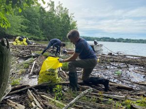 Head of iSustain business development and boardmember of Keep the Tennessee River Beautiful, Mark Huber, bags litter during the Chickamauga Lake clean up.