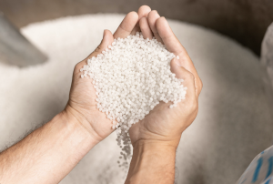 A person holding recycled polypropylene from recycled super sacks. 